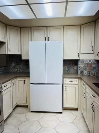 a white refrigerator freezer sitting in a kitchen
