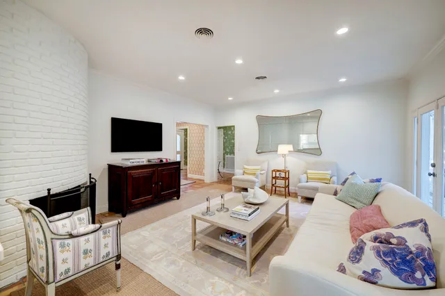 a kitchen with a dining table chairs and refrigerator