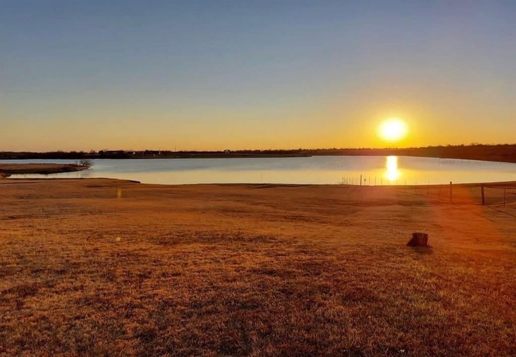 4378 Old Fort Worth Road Midlothian, TX 76065 - Photo 3 of 6 Expansive views of the lake at sunset, with a large open field in the foreground