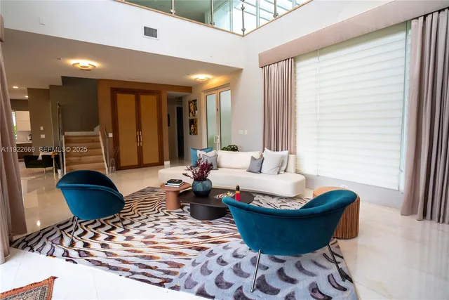 a living room with furniture and a large window