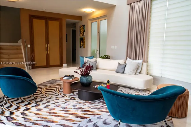 a living room with furniture and a rug