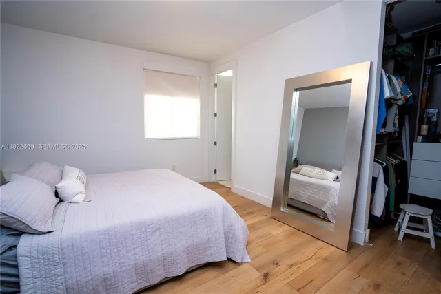 a bedroom with a bed and a mirror
