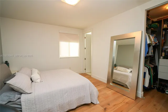 a bedroom with a bed and a mirror