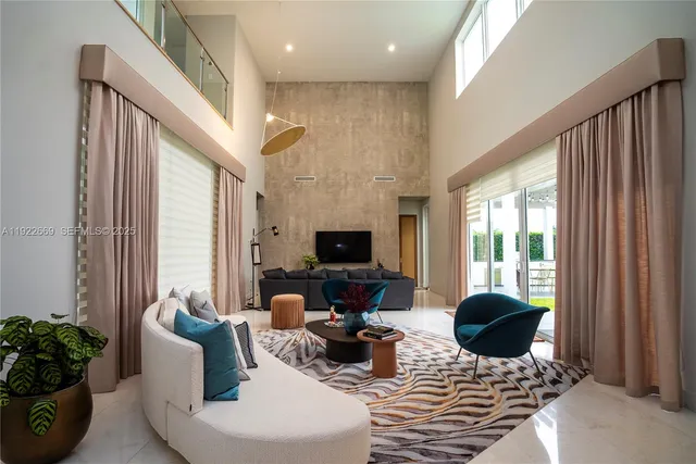 a living room with furniture a flat screen tv and a large window