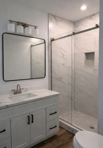 a bathroom with a sink toilet and shower