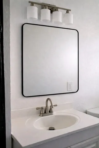 a bathroom with a sink and mirror