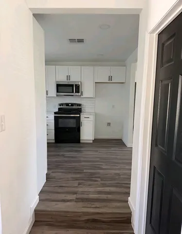 a kitchen with cabinets and a stove