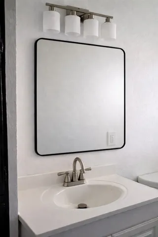 a bathroom with a sink and mirror