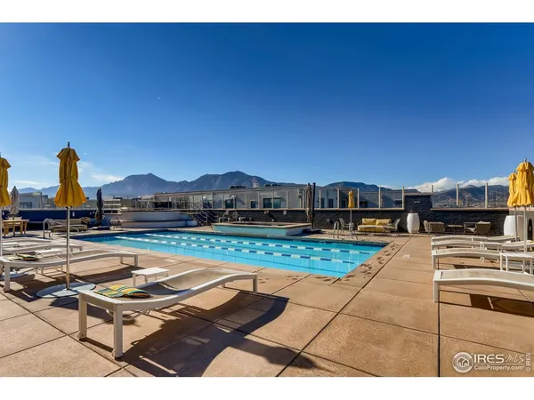 a view of a swimming pool with an outdoor space and seating area