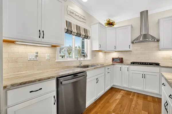 a kitchen with granite countertop stainless steel appliances sink and cabinets