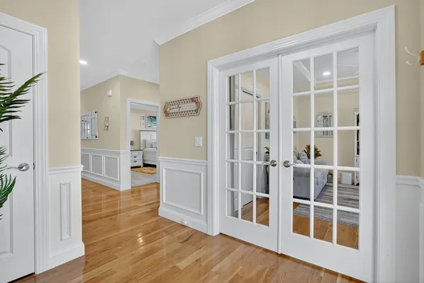 a view of a big room with wooden floor and windows