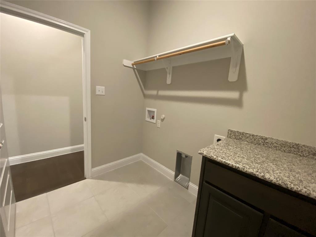209 Johnson Street Granbury, TX 76048 - Photo 38 of 40 Laundry room featuring hookup for an electric dryer, tile flooring, and hookup for a washing machine