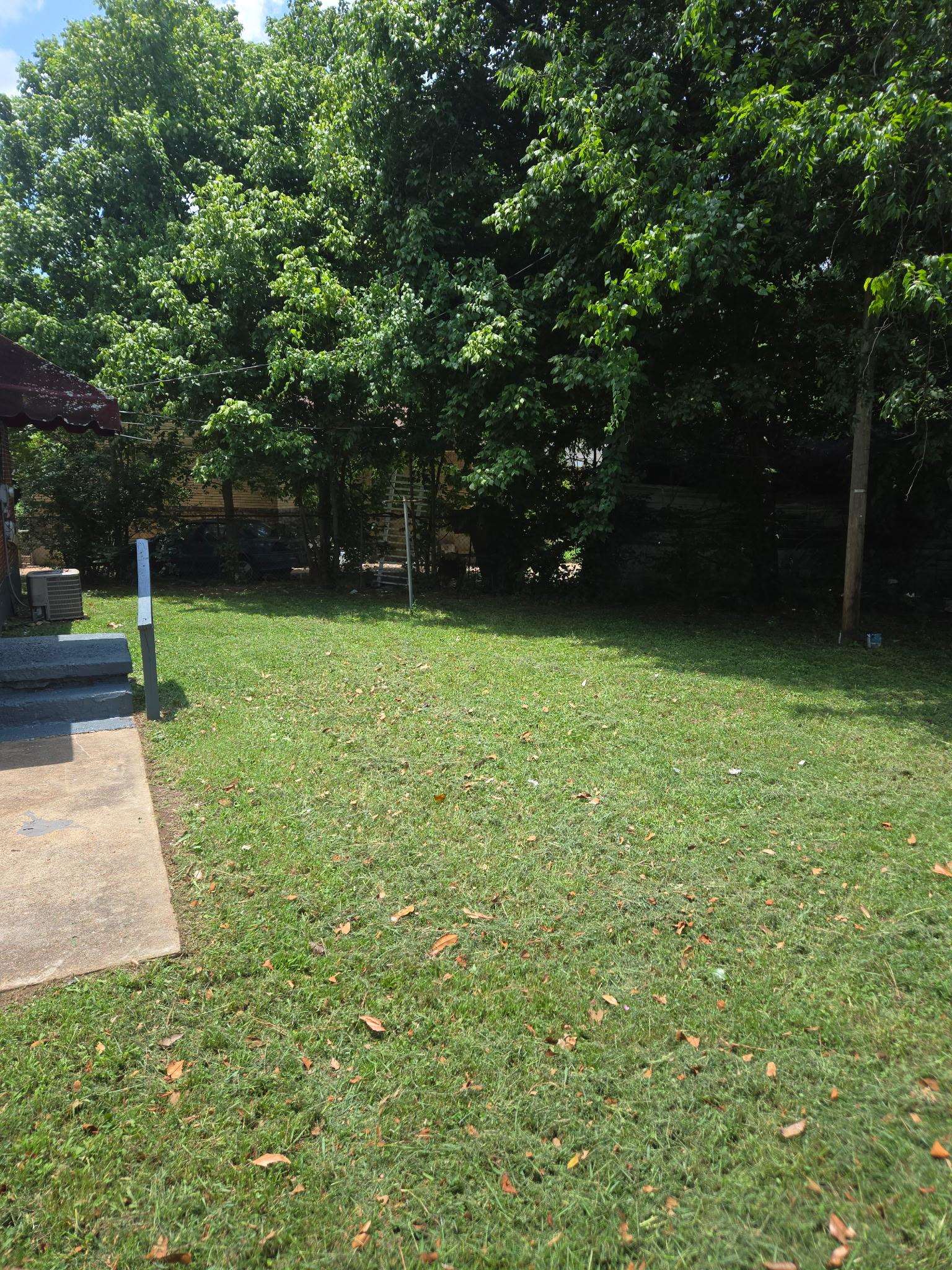 1510 Gausco Road Memphis, TN 38106 - Photo 8 of 10 Expansive grassy yard with mature trees providing a natural canopy