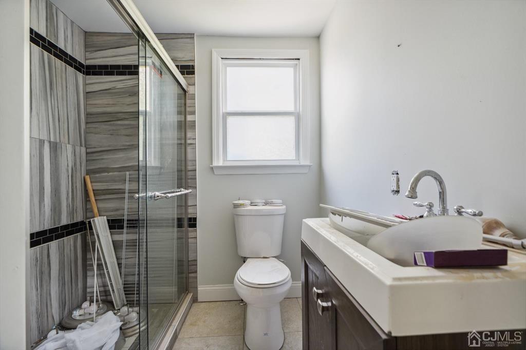 212 Huff Avenue Manville, NJ 08835 - Photo 15 of 22 a bathroom with a toilet sink and shower