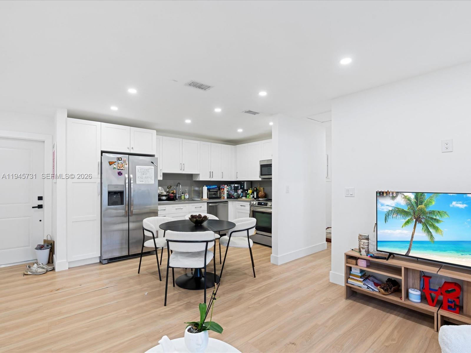 6510 Southwest 59th Place South Miami, FL 33143 - Photo 17 of 23 a kitchen with stainless steel appliances kitchen island granite countertop a refrigerator and a stove top oven
