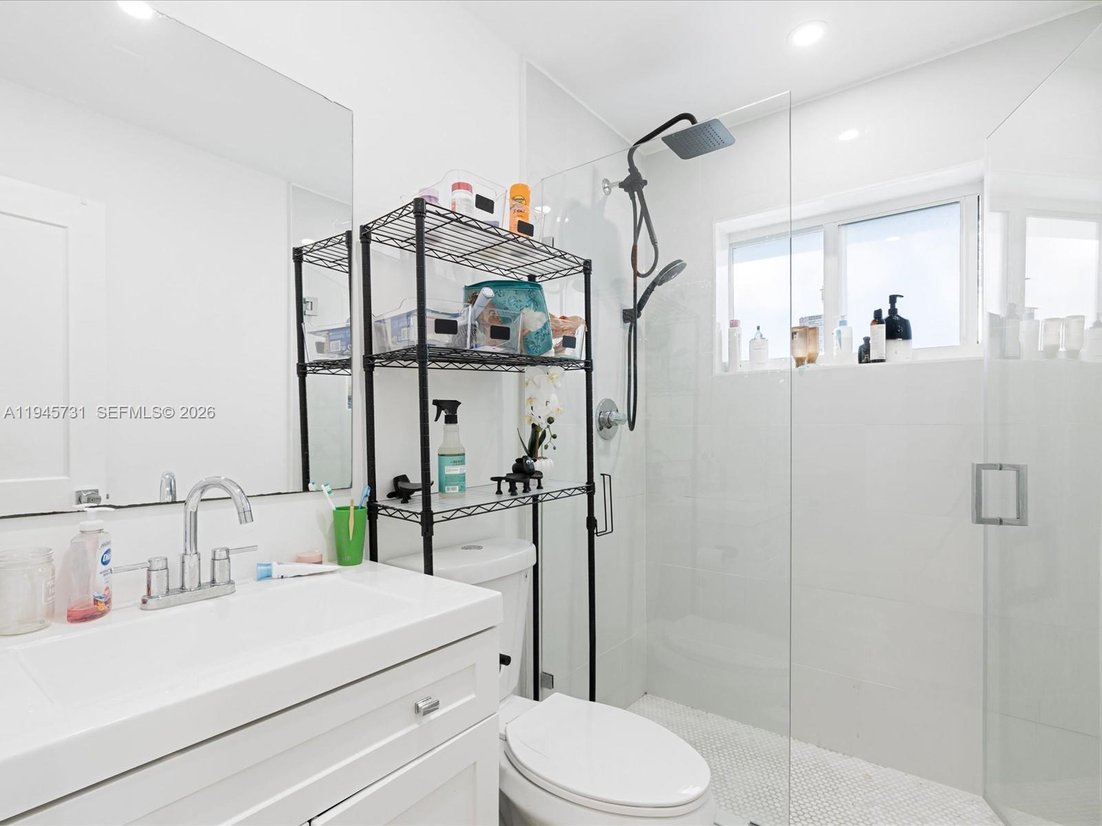 6510 Southwest 59th Place South Miami, FL 33143 - Photo 18 of 23 a bathroom with a sink a toilet and shower