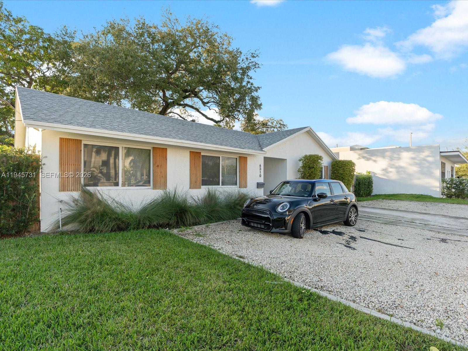 6510 Southwest 59th Place South Miami, FL 33143 - Photo 2 of 23 a view of backyard of house with outdoor seating and green space