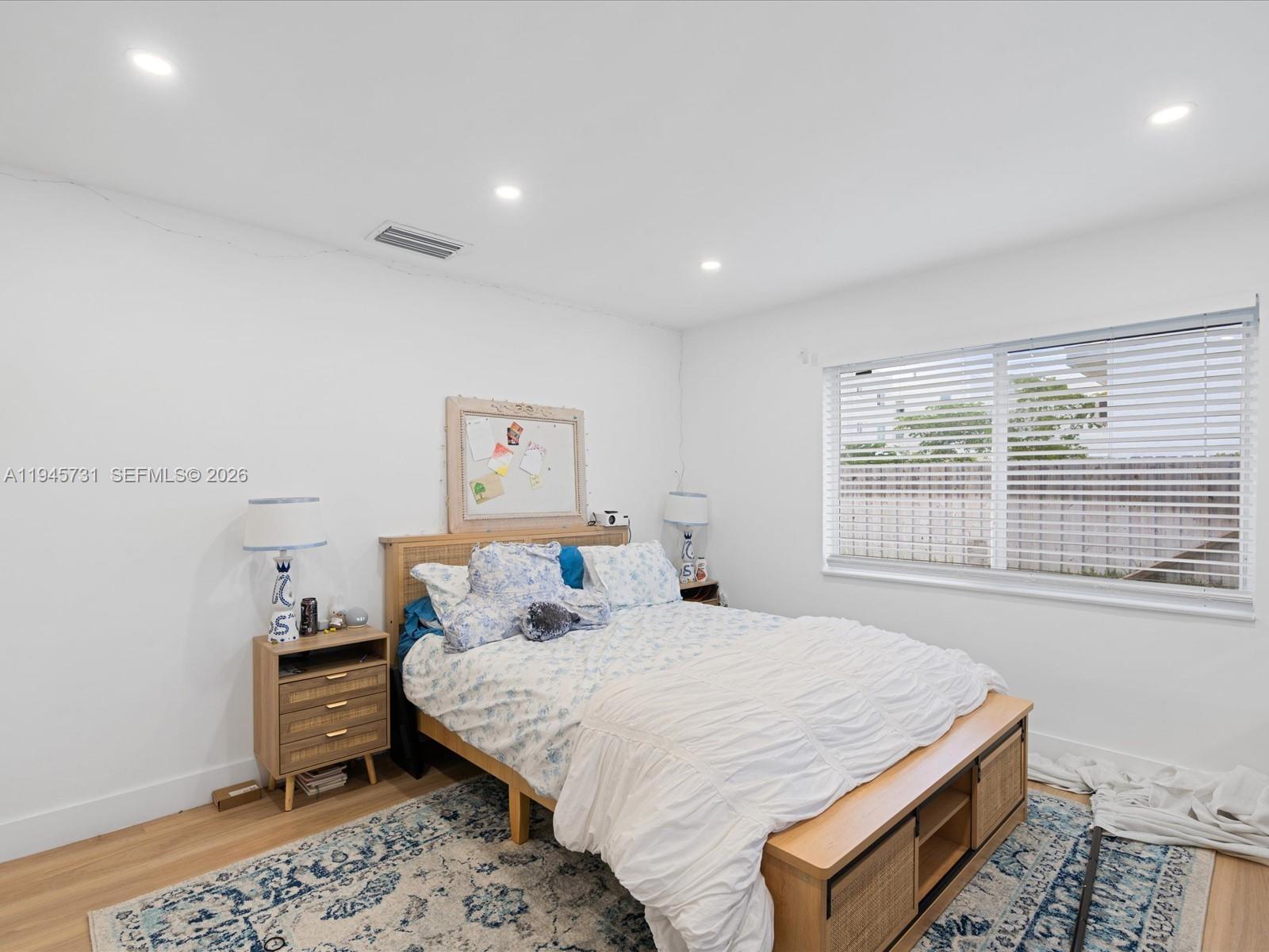 6510 Southwest 59th Place South Miami, FL 33143 - Photo 22 of 23 a bedroom with a bed and wooden floor