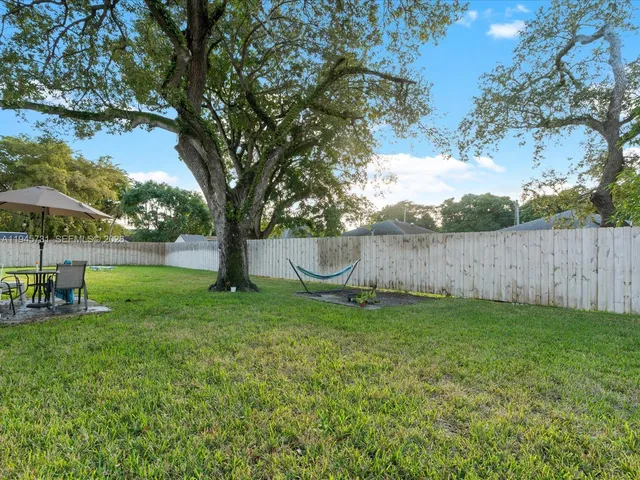 a green field with lots of trees in it