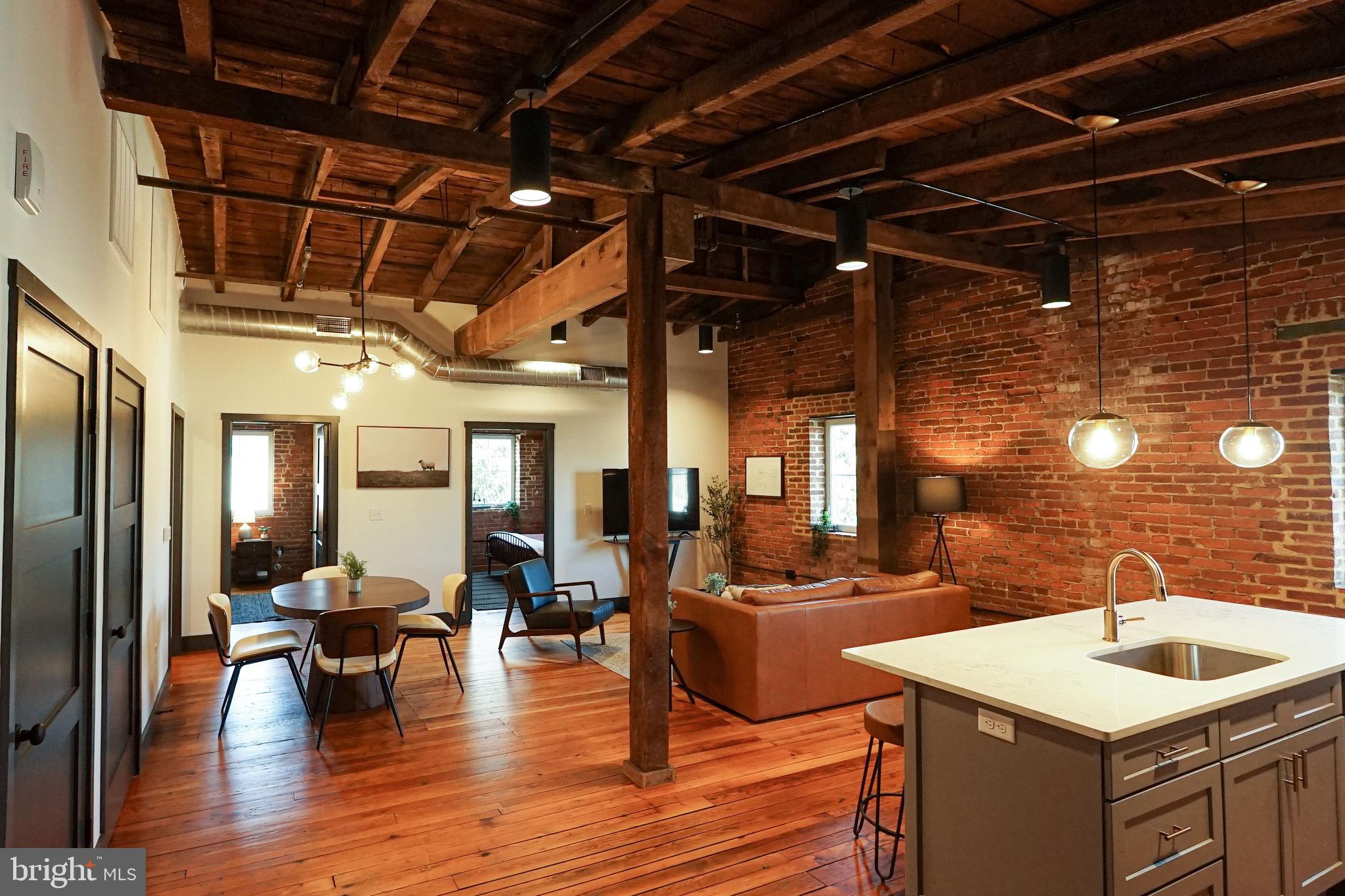 437 West Grant Street, Unit 304 Lancaster, PA 17603 - Photo 1 of 37 a view of a dining room with furniture a chandelier and wooden floor