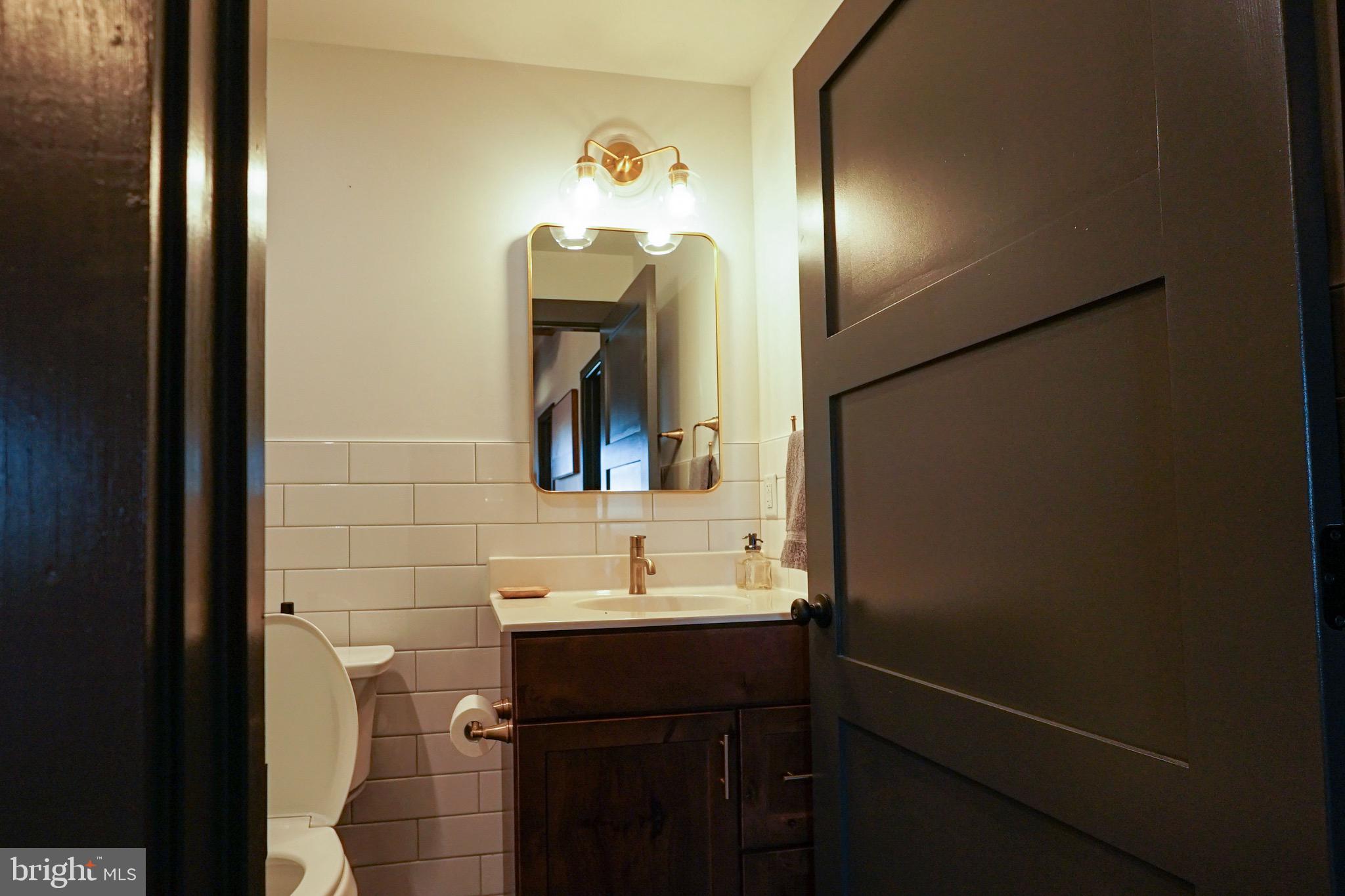 437 West Grant Street, Unit 304 Lancaster, PA 17603 - Photo 11 of 37 a bathroom with a sink and a mirror