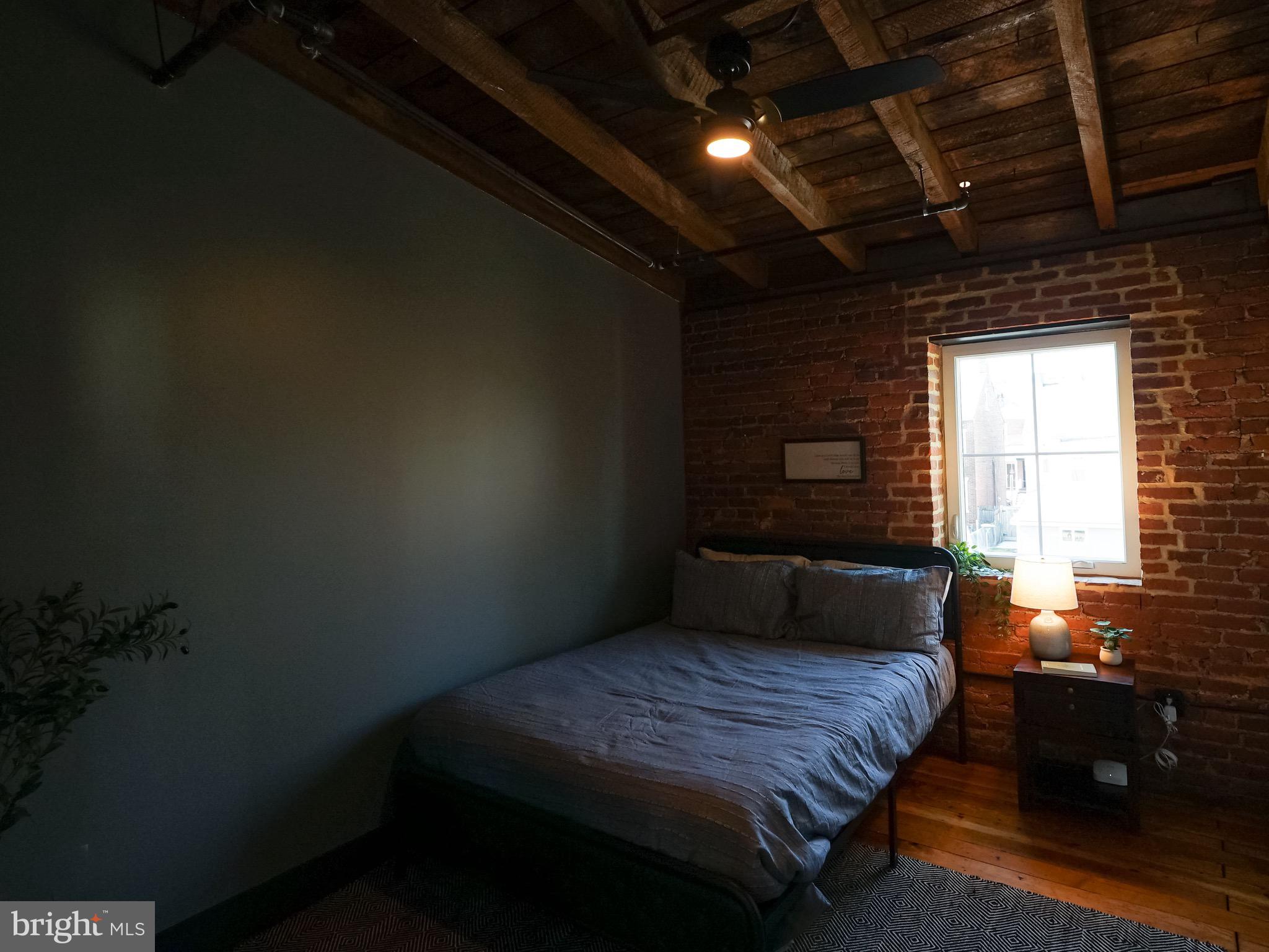 437 West Grant Street, Unit 304 Lancaster, PA 17603 - Photo 12 of 37 a bedroom with a bed and a window