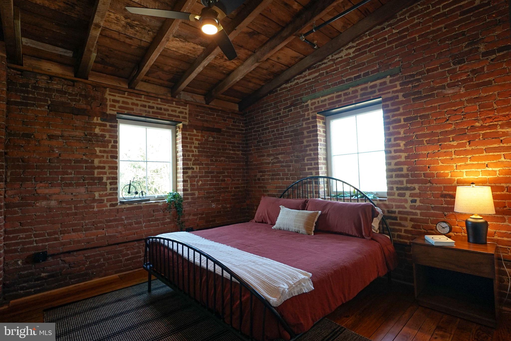 437 West Grant Street, Unit 304 Lancaster, PA 17603 - Photo 4 of 37 a bedroom with a bed and wooden floor