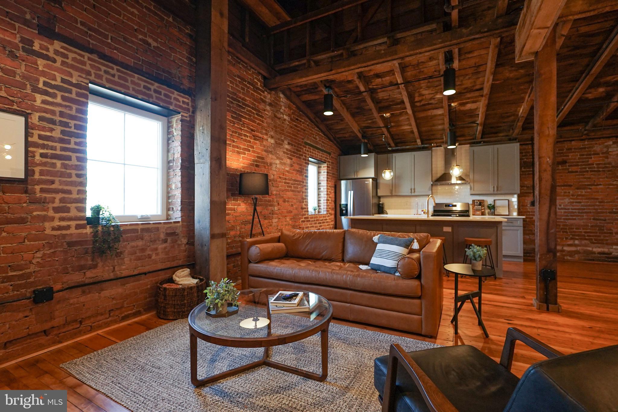 437 West Grant Street, Unit 304 Lancaster, PA 17603 - Photo 5 of 37 a living room with furniture and a glass door