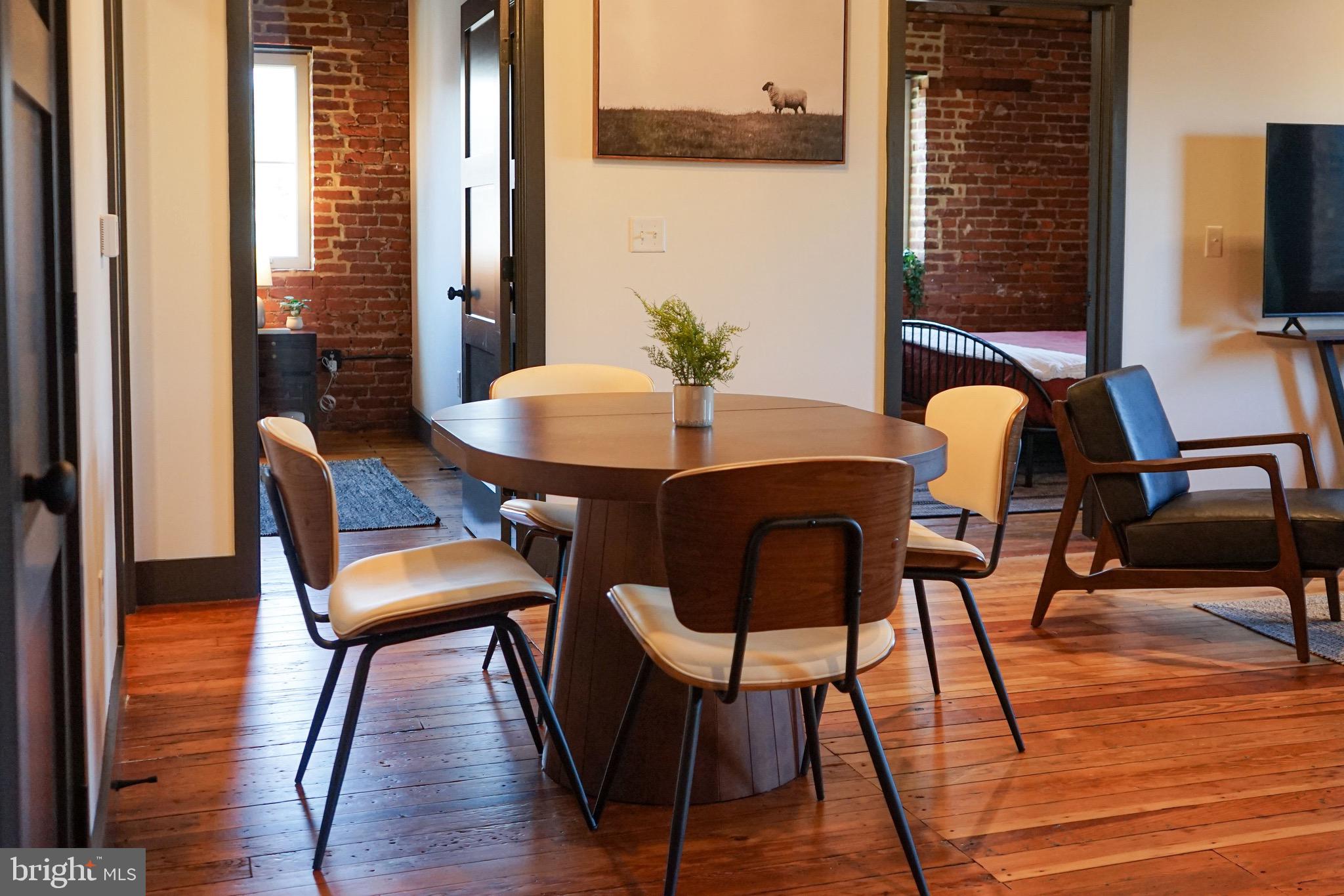 437 West Grant Street, Unit 304 Lancaster, PA 17603 - Photo 7 of 37 a view of a dining room with furniture and wooden floor
