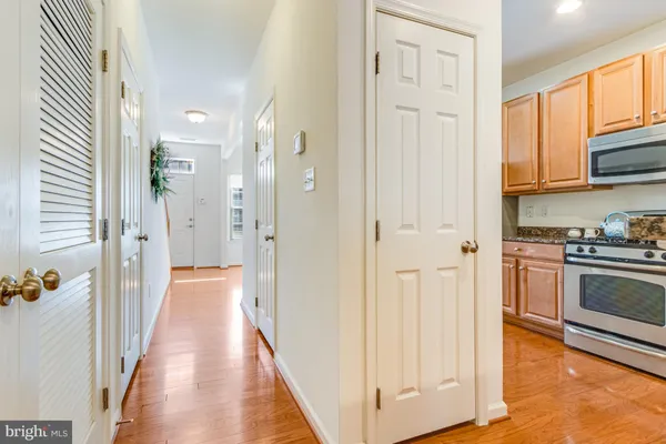 a view of a kitchen with stainless steel appliances granite countertop a refrigerator and a stove top oven