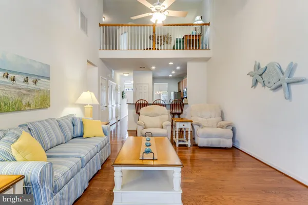 a living room with furniture and a book shelf