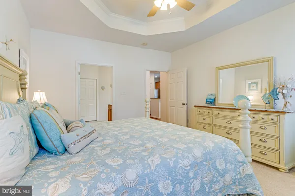 a bedroom with a large bed and a dresser