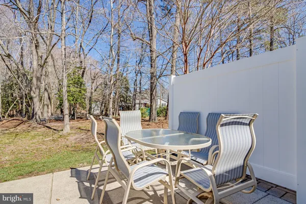 a view of a chairs and table in backyard