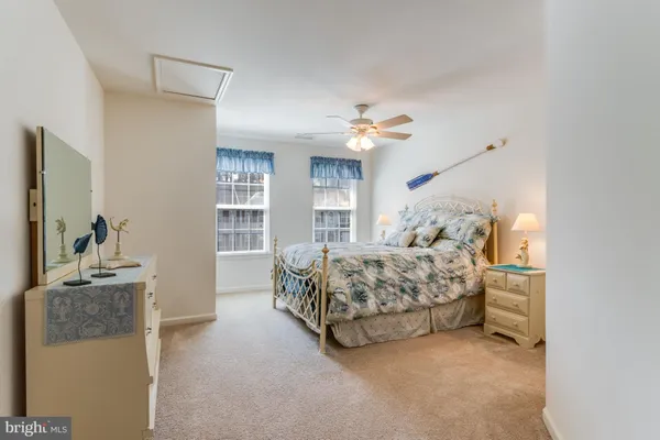 a bedroom with two beds and a chandelier