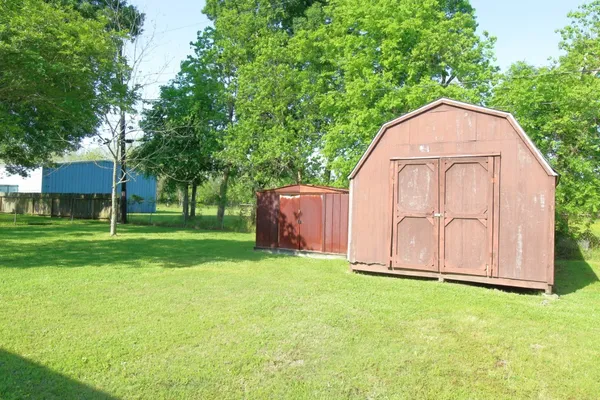 a view of a backyard with large trees
