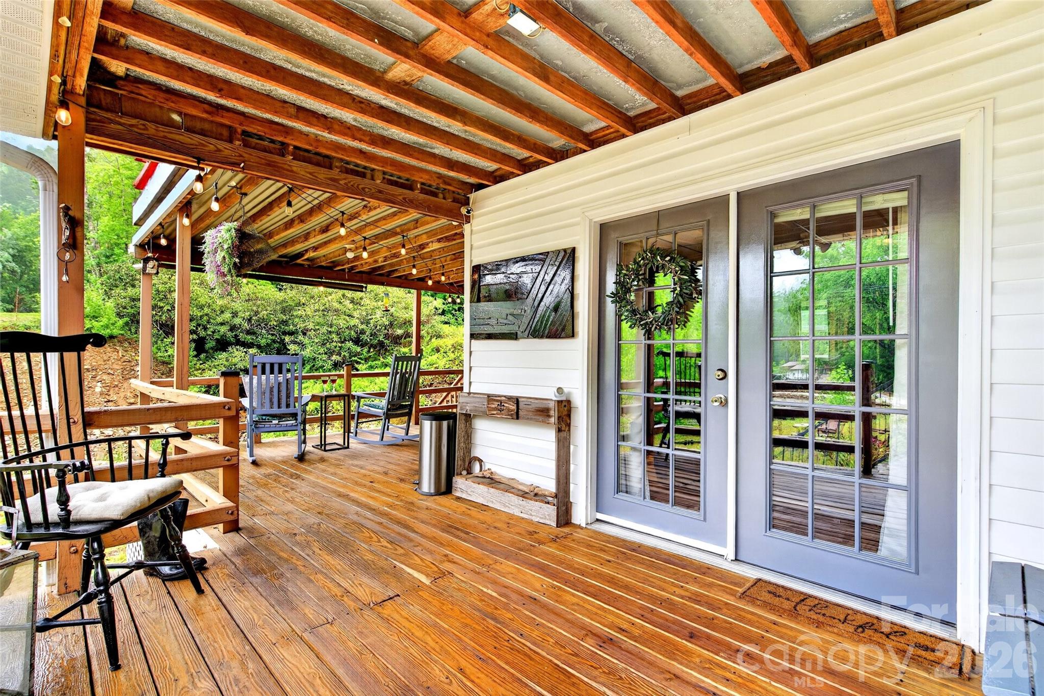 227 Locust Cove Road Marion, NC 28752 - Photo 25 of 34 a view of a patio with table and chairs and wooden floor