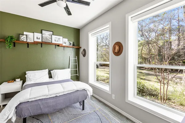 a bedroom with a bed and a window