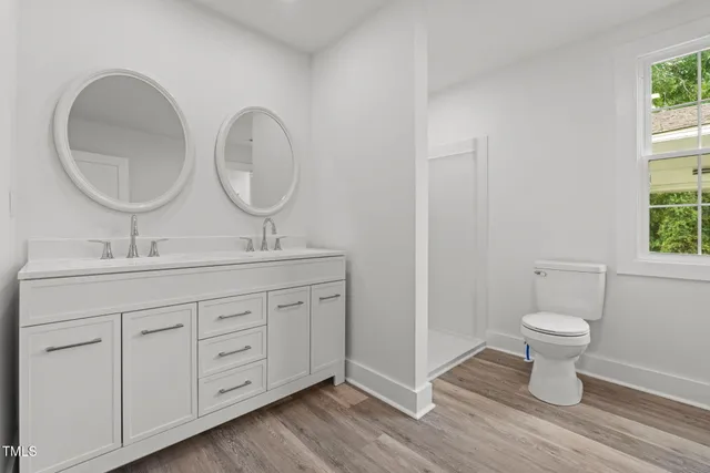 a bathroom with a toilet a sink and a mirror