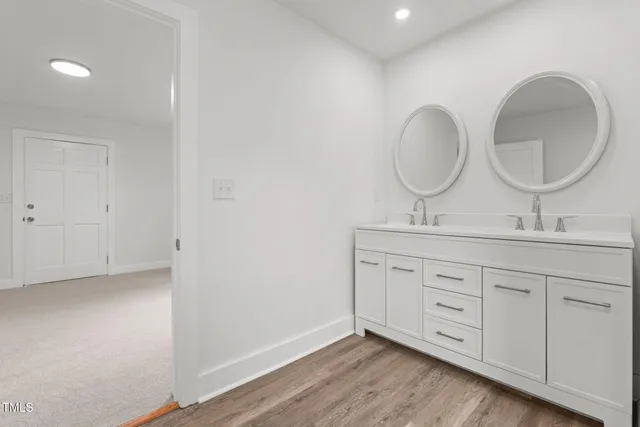 a bathroom with a double vanity sink and a mirror
