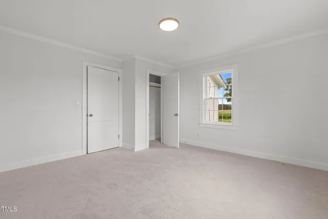 an empty room with windows and closet