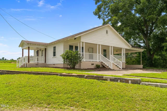a view of a house with swimming pool and a yard
