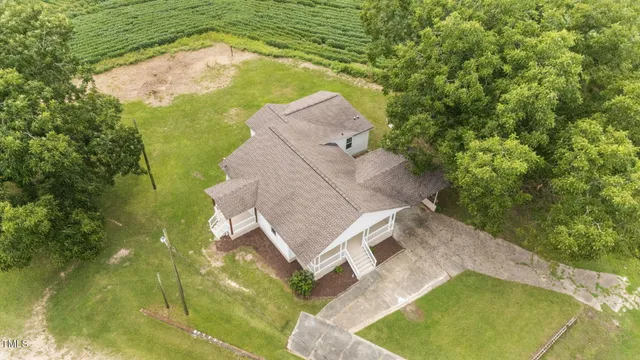 an aerial view of a house with a yard