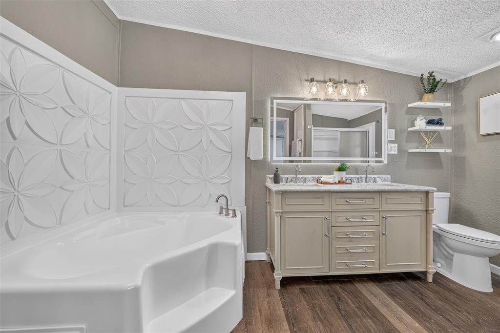 449 Big Salty Lane Springtown, TX 76082 - Photo 18 of 25 Corner soaking tub with decorative floral-patterned wall panels