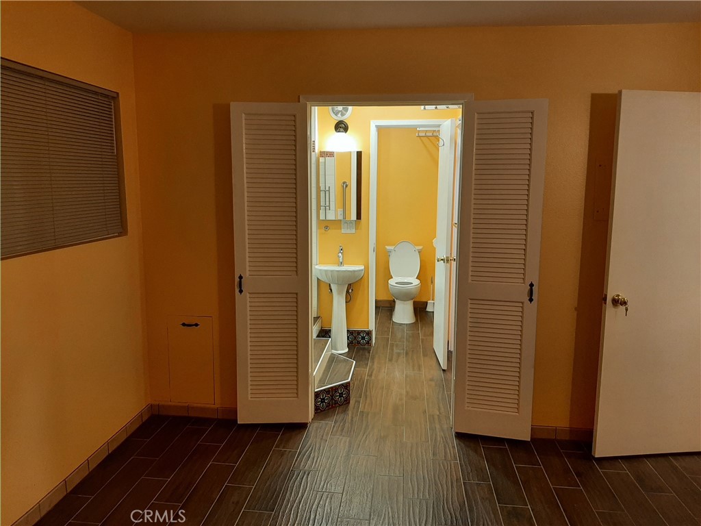 12592 Montecito Road, Unit 9 Seal Beach, CA 90740 - Photo 14 of 34 a view of a room with wooden floor and a view of bedroom