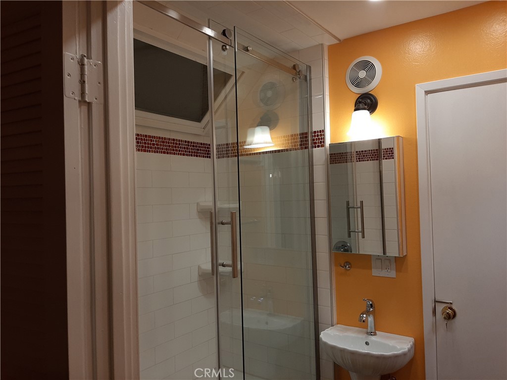 12592 Montecito Road, Unit 9 Seal Beach, CA 90740 - Photo 20 of 34 a bathroom with a shower and a sink