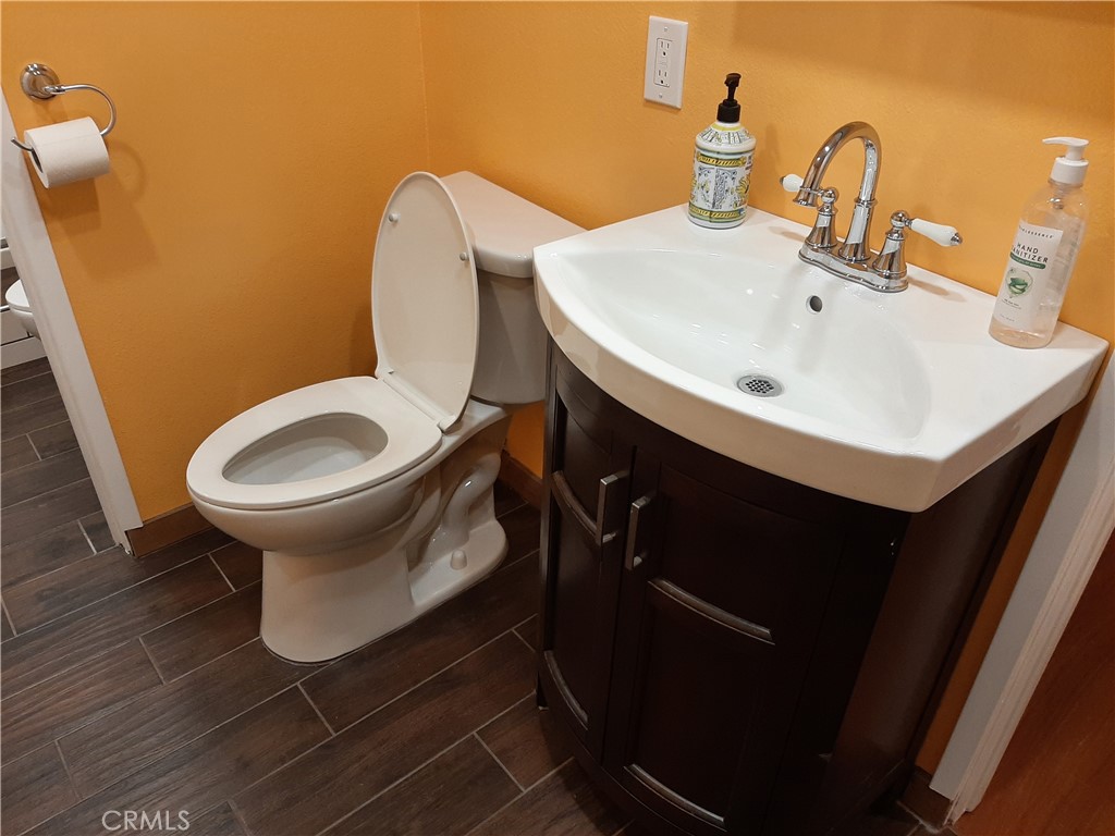 12592 Montecito Road, Unit 9 Seal Beach, CA 90740 - Photo 23 of 34 a bathroom with a sink toilet and a mirror