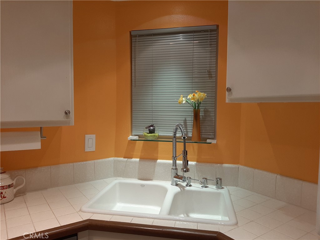 12592 Montecito Road, Unit 9 Seal Beach, CA 90740 - Photo 27 of 34 a bathroom with a sink and a mirror