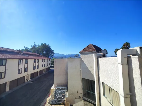 a view of balcony with wooden floor and fence