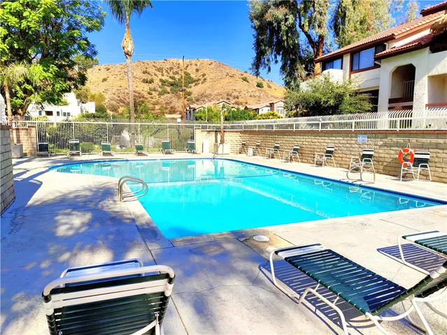 a view of a swimming pool with an outdoor space and seating area