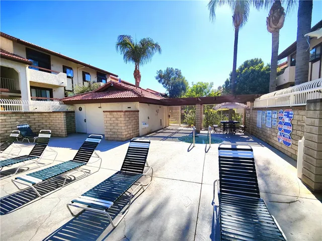 a view of a patio with table and chairs with wooden floor and fence